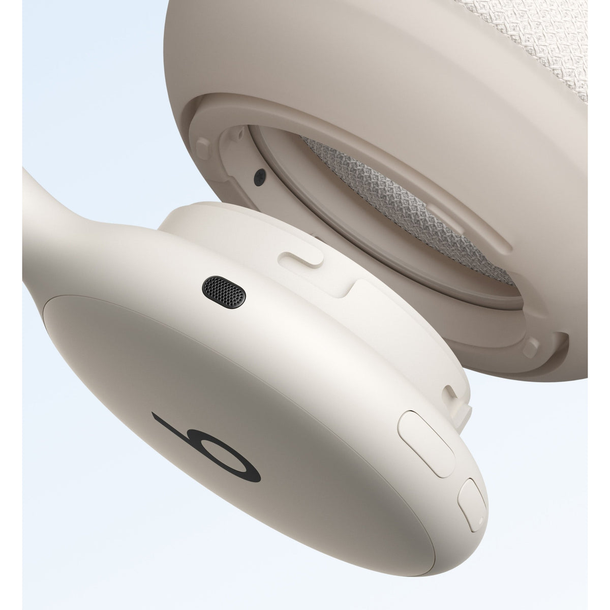 Beige Beats 360 headphone side profile showing controls, logo, and soft matte speaker grille at Nuvana Tech