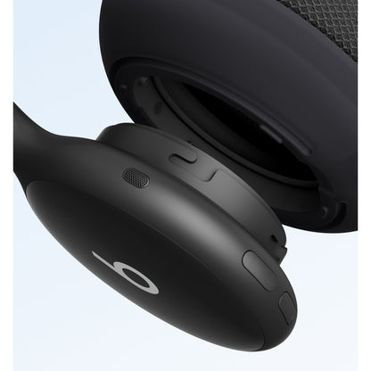 Close-up of black Beats 360 headphone controls and speaker grille