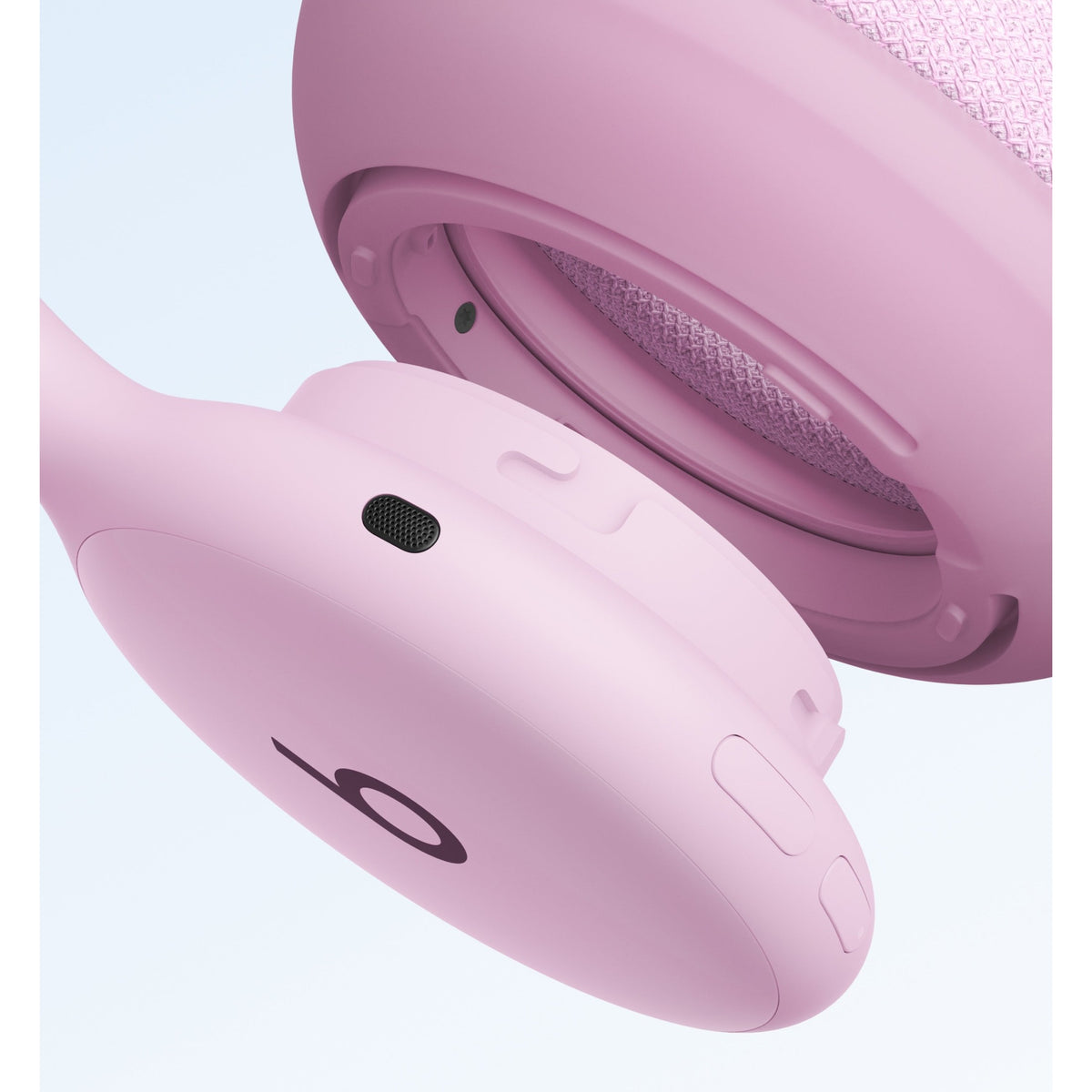 Matte pink Beats 360 headphones close-up with control buttons and textured knit interior at Nuvana Tech