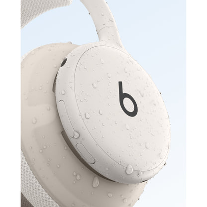 Beige Beats 360 headphones demonstrating IPX4 sweat and water resistance with droplets at Nuvana Tech