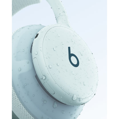 Light blue Beats 360 headphones showing IPX4 sweat resistance with water droplets